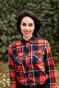 Portrait of beautiful woman while standing outdoors