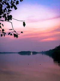 Scenic view of lake against sky at sunset