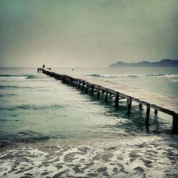 Pier on sea against sky