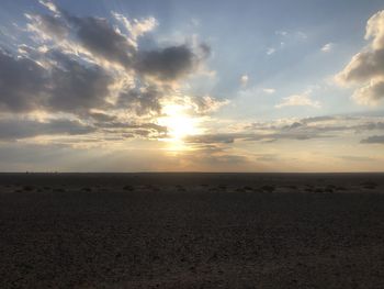 Scenic view of beach against sky during sunset