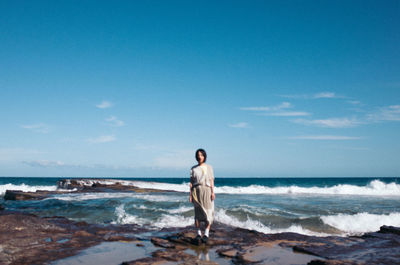 Rear view of man standing on beach