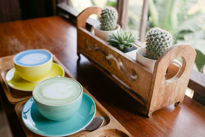 High angle view of coffee and potted plant on table