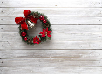 Directly above shot of christmas wreath on hardwood floor