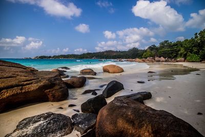 Rocks on beach against sky