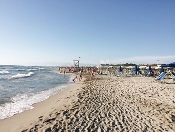 Scenic view of beach against blue sky