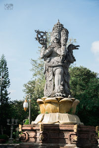 Low angle view of statue against sky