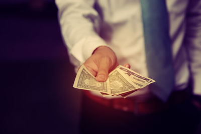 Close-up of hand holding paper
