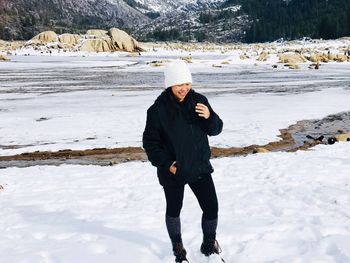 Full length of man standing in snow