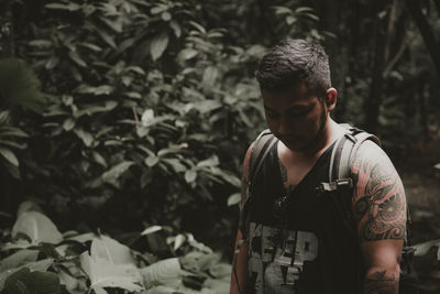 A view of a man looking down, inside the forest