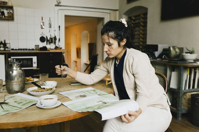 Young woman using laptop at home