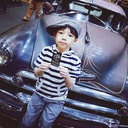 Full length of cute boy in car