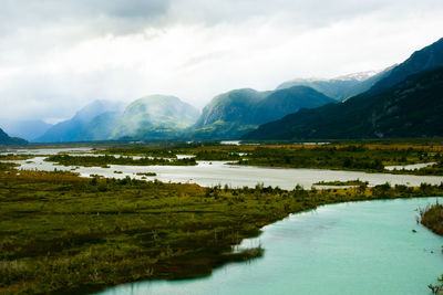 Scenic view of lake and mountains against sky