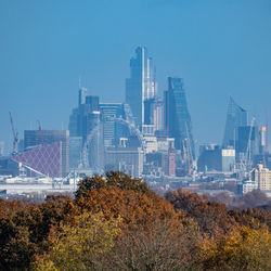 Modern buildings in city against clear sky