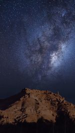 Low angle view of mountain against sky at night