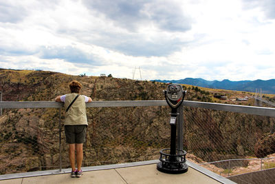 Rear view of a man overlooking landscape