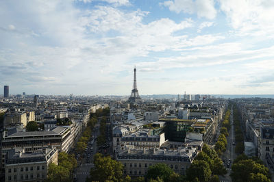 View of cityscape against cloudy sky