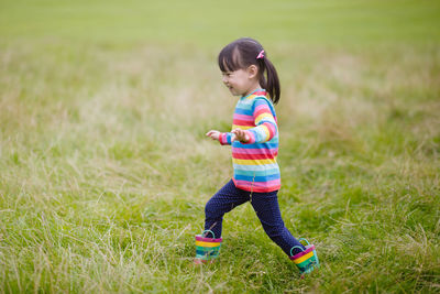 Full length of cute baby girl on field