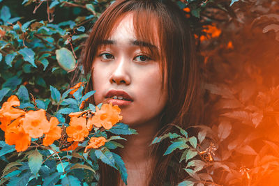 Portrait of woman with red leaves