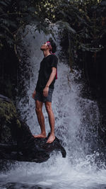 Full length of man standing in water