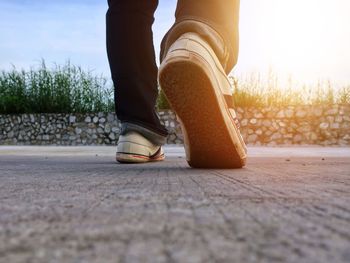 Low section of man walking on footpath