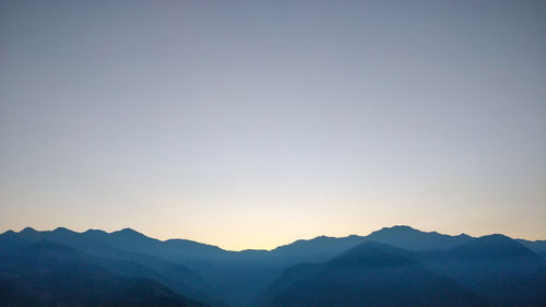 Scenic view of silhouette mountains against clear sky