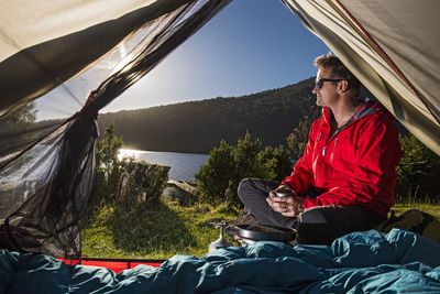 Man camping at the chilean lake district, pucon, chile