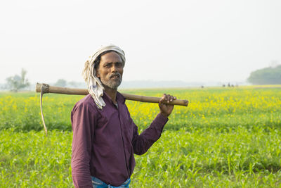 Portrait of man standing in field