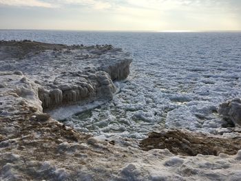 View of frozen sea against sky