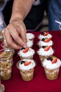 Midsection of man holding ice cream on table