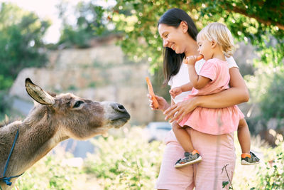 Side view of woman with goat