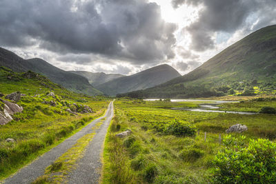 Country road leading trough black valley,  macgillycuddys reeks mountains, ring of kerry, ireland