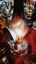 Close-up of illuminated light bulb on table in restaurant