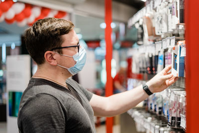 Man holding headphones in store