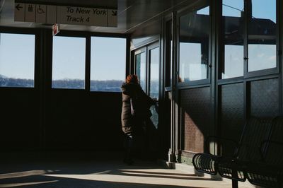 Full length of woman standing on bench