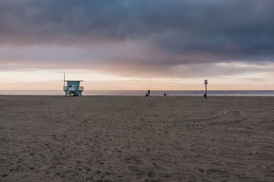 Scenic view of beach against sky during sunset