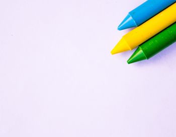 Close-up of colored pencils against white background