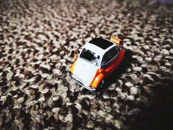 High angle view of toy car on rug