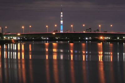 View of bridge over river at night