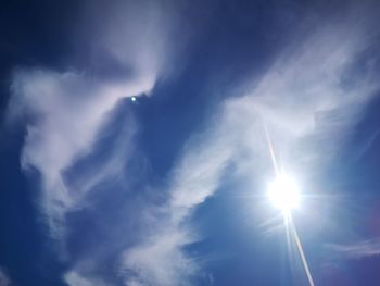 Low angle view of bright sun in sky
