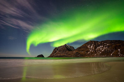 Scenic view of mountains against sky at night