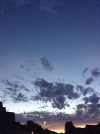 Low angle view of silhouette trees against sky