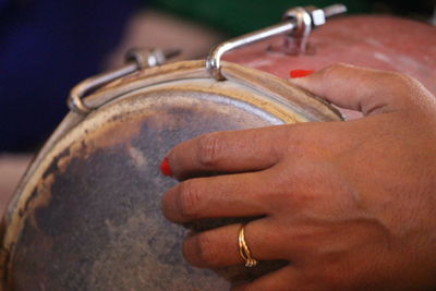 Close-up of woman hand on metal