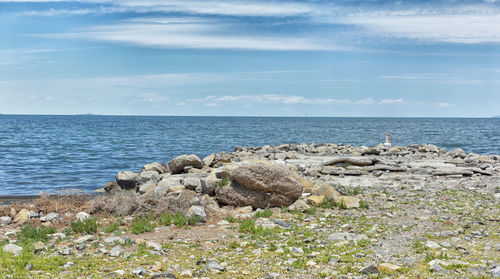 Rocks on beach against sky