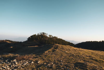 Scenic view of land against clear blue sky