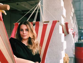 Portrait of smiling young woman relaxing in hammock