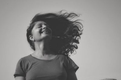 Portrait of woman against white background