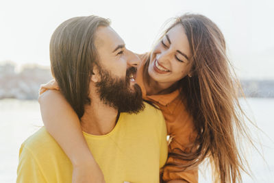 Portrait of young couple kissing outdoors