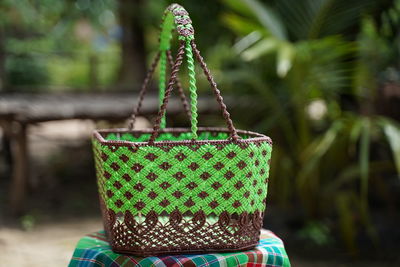 Close-up of wicker basket on plant in field