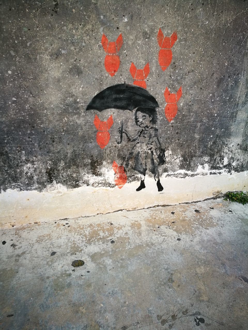 RED UMBRELLA AGAINST WALL