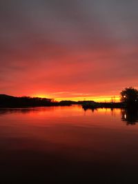 Scenic view of lake against romantic sky at sunset